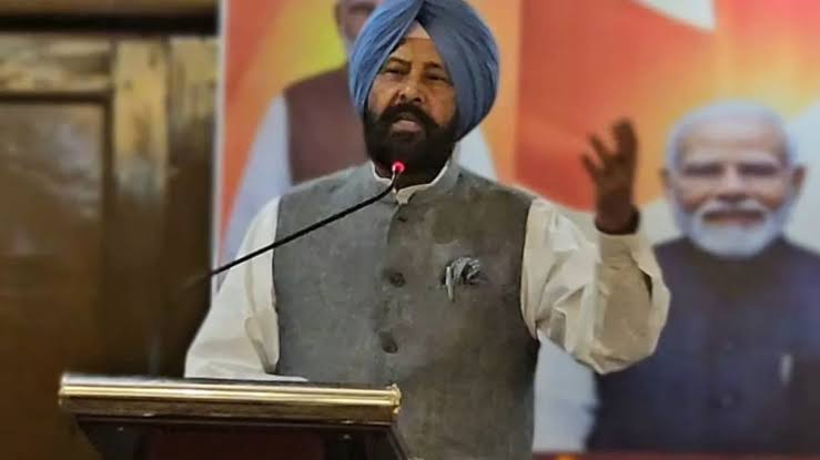 Kewal Singh Dhillon speaking from a lectern at an indoor party function