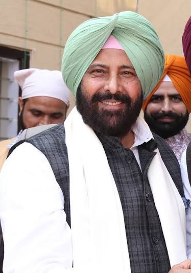 Kewal Singh Dhillon in a waistcoat and white scarf at a public occasion