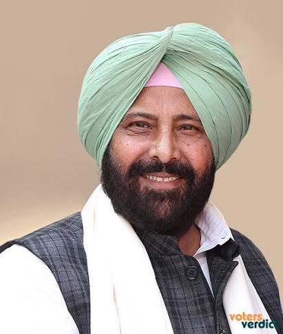 Portrait of Kewal Singh Dhillon in a green turban and dark waistcoat