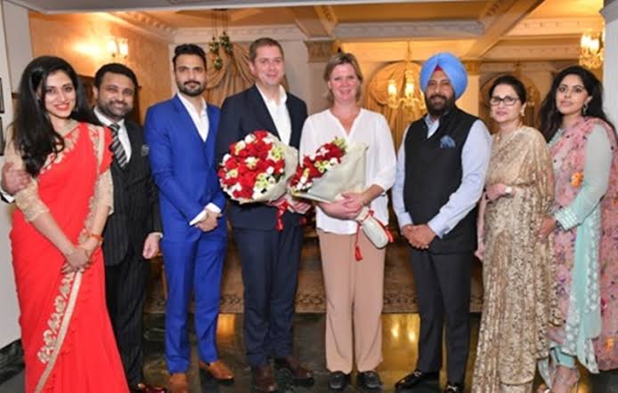 Kewal Singh Dhillon among a group at a formal reception, with guests holding bouquets