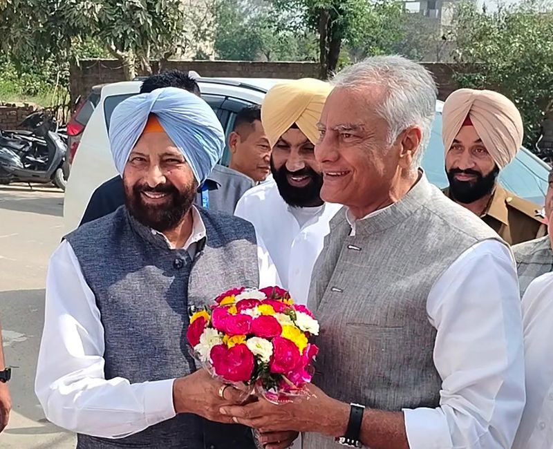 Kewal Singh Dhillon greeting a senior party colleague with a bouquet outside a public venue