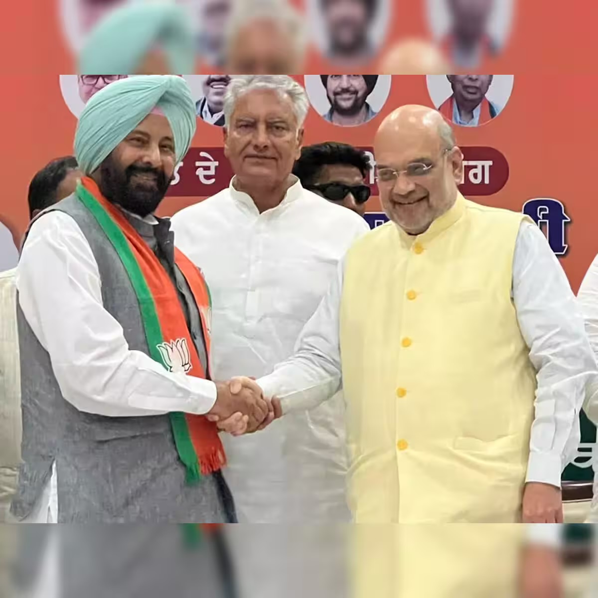 Kewal Singh Dhillon shaking hands with Union Home Minister Amit Shah as he joins the Bharatiya Janata Party, with Sunil Jakhar standing behind